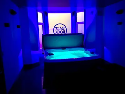 a blue room with a tub with a sign on it at Saltrock luxury apartment in Blackpool