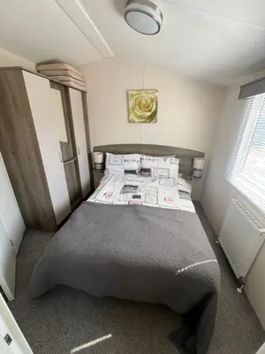a bedroom with a large bed in a room at 3 Bedroom Modern Caravan Sleeps up to 8 in Millom