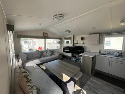a living room with a couch and a table at 3 Bedroom Modern Caravan Sleeps up to 8 in Millom