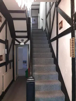 a stairway in a building with a stair case at Deneside Guest House in Blackpool
