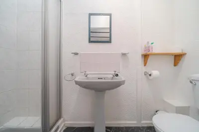 a bathroom with a sink and a shower at Deneside Guest House in Blackpool