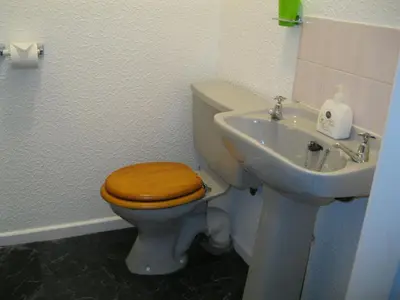 a bathroom with a toilet and a sink at Deneside Guest House in Blackpool