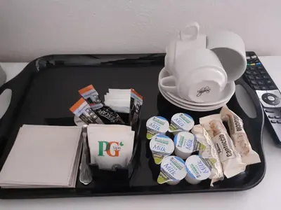a suitcase with food and other items on a table at Deneside Guest House in Blackpool