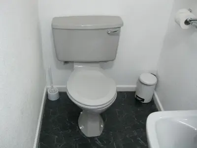 a bathroom with a white toilet and a sink at Deneside Guest House in Blackpool