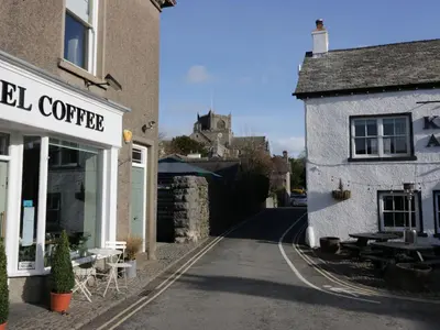 a street with a coffee shop and a building at 1 Tower House in Grange Over Sands