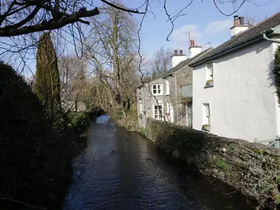 a river in a village next to houses at 1 Tower House in Grange Over Sands