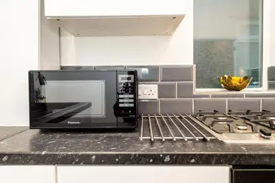 a microwave oven sitting on a counter in a kitchen at The Blossoms Studio Apartments in Liverpool