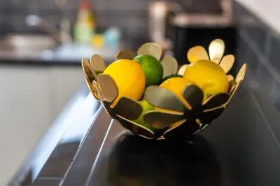 a bowl of fruit sitting on top of a stove at The Blossoms Studio Apartments in Liverpool