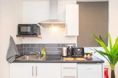 a kitchen with a sink and a microwave at The Blossoms Studio Apartments in Liverpool