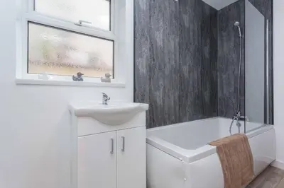 a white bathroom with a sink and a bath tub at Cherry Property - Passionfruit Suite in Blackpool