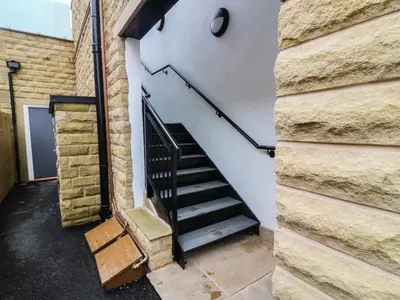 a staircase in a building with a brick wall at Market Lounge in Clitheroe
