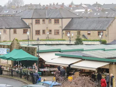 a group of people walking around a market with buildings at Market Lounge in Clitheroe