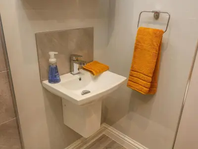 a bathroom with a white sink and a mirror at Market Lounge in Clitheroe