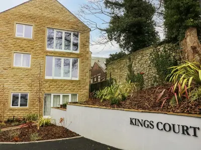 a house with the kings court sign in front of it at Market Lounge in Clitheroe