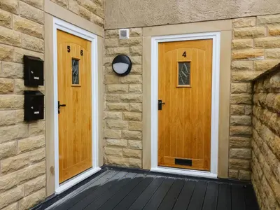 two wooden doors on the side of a brick wall at Market Lounge in Clitheroe
