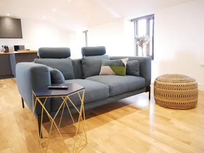 a living room with a blue couch and a table at Scandic House, 1 Bed Apartments, Sleeps 2, Ulverston in Ulverston