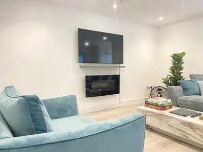a living room with two blue chairs and a tv at Eagles Cottage, 3 - Bed, Sleeps 6, Pets Welcome - Ulverston in Ulverston