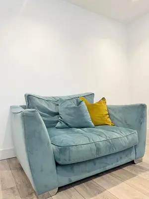 a blue couch with a yellow pillow on it at Eagles Cottage, 3 - Bed, Sleeps 6, Pets Welcome - Ulverston in Ulverston