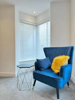 a blue couch with a yellow pillow and a table at Eagles Cottage, 3 - Bed, Sleeps 6, Pets Welcome - Ulverston in Ulverston