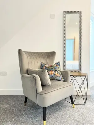 a gray chair sitting in front of a mirror at Eagles Cottage, 3 - Bed, Sleeps 6, Pets Welcome - Ulverston in Ulverston