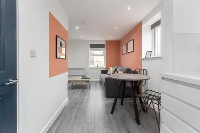 a living room with a couch and a table at Charles Alexander Short Stay - The Gateway in Blackpool