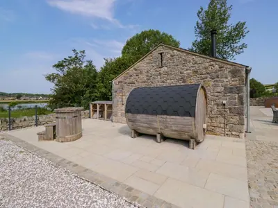 a stone building with a large object in a patio at Limestone in Ulverston