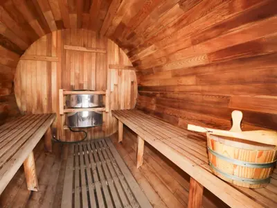an inside view of a wooden cabin with benches and a stove at Limestone in Ulverston