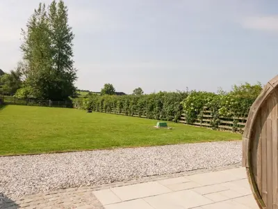 a garden with a fence and a field of grass at Limestone in Ulverston