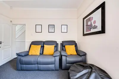 two blue chairs sitting in a living room at Ursula Sparkle Stays in Liverpool