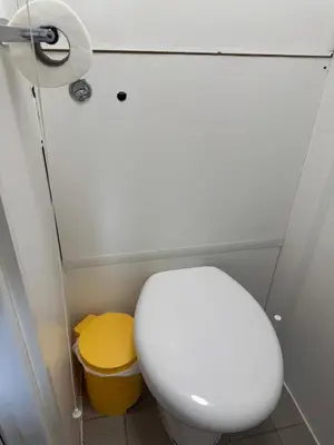a small bathroom with a toilet and a roll of toilet paper at The Clarendon Hotel in Blackpool