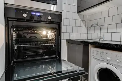an oven with its door open in a kitchen at 1 Bedroom Swinley Apartment l Free Parking l Wigan Royal Infirmary l Haigh Hall l Central Location in Wigan