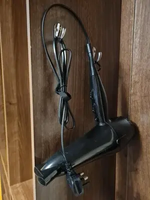 a black umbrella hanging on a wooden door at 1 Bedroom Swinley Apartment l Free Parking l Wigan Royal Infirmary l Haigh Hall l Central Location in Wigan