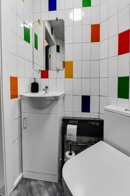 a bathroom with a toilet and a sink and a mirror at 1 Bedroom Swinley Apartment l Free Parking l Wigan Royal Infirmary l Haigh Hall l Central Location in Wigan