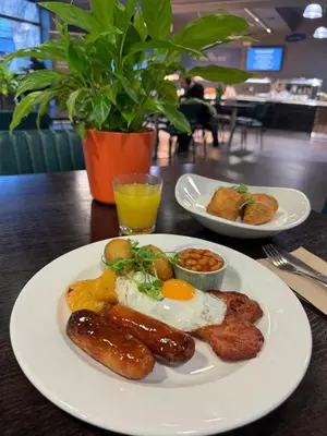a plate of breakfast food with sausage and eggs on a table at Lancaster University in Lancaster