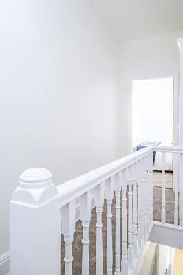 a white staircase with white railings in a house at Hibbert Galore in Barrow in Furness