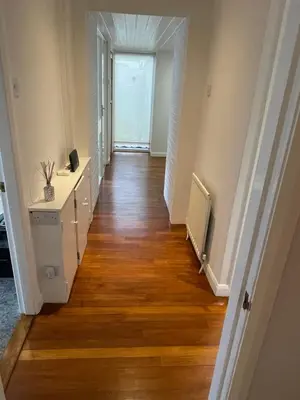 a hallway of a home with wooden floors at 'Sounion' - Fabulous, spacious modern house with large private garden in Leafy Lytham in Lytham St Annes