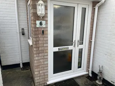 a door to a house with the number six at 'Sounion' - Fabulous, spacious modern house with large private garden in Leafy Lytham in Lytham St Annes