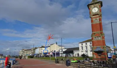 a clock tower in the middle of a town at The Croston promenade balcony apartment- Morecambe central promenade, beach front and sea views in Morecambe