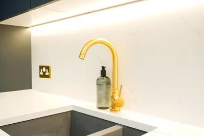 a kitchen sink with a soap bottle on it at NOVU Apartments Duke Street Liverpool in Liverpool