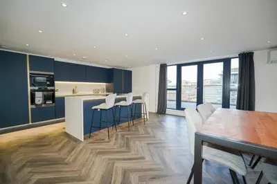 a kitchen and dining room with a table and chairs at NOVU Apartments Duke Street Liverpool in Liverpool