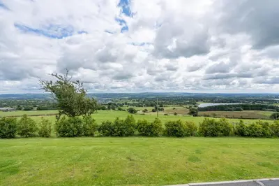 a view from the top of a hill with a green field at Pendle View Sleeps 8 with Hot Tub in Longridge