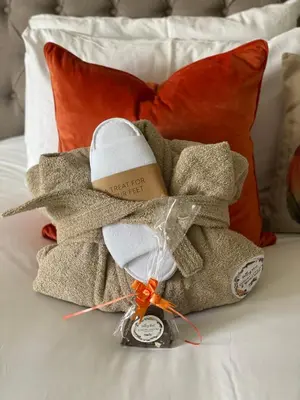 a pile of towels sitting on top of a bed at Pendle View Sleeps 8 with Hot Tub in Longridge