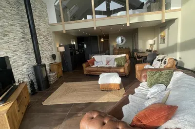 a living room with two couches and a tv at Pendle View Sleeps 8 with Hot Tub in Longridge