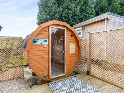 a small wooden shed with a door in a yard at Pendle View Lodge in Altham