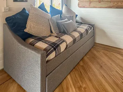 a couch with pillows on it in a room at Pendle View Lodge in Altham