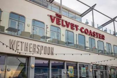 a building with a welcome sign on the side of it at Withnell Stays - Apartment Three in Blackpool