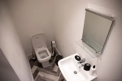 a small bathroom with a sink and a toilet at Withnell Stays - Apartment Three in Blackpool