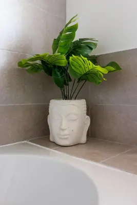 a plant in a vase sitting on top of a bath tub at Everton Valley House - Air Host & Stay - Close to city centre in Liverpool