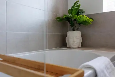 a bath tub with a vase with a plant in it at Everton Valley House - Air Host & Stay - Close to city centre in Liverpool