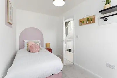 a white bedroom with a bed and a staircase at Everton Valley House - Air Host & Stay - Close to city centre in Liverpool